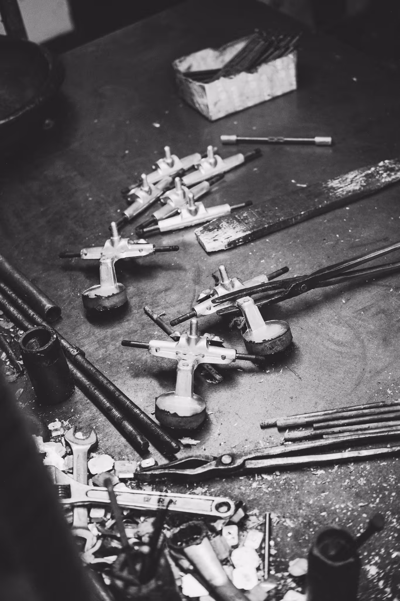 Skateboard trucks and hand tools on the factory workbench